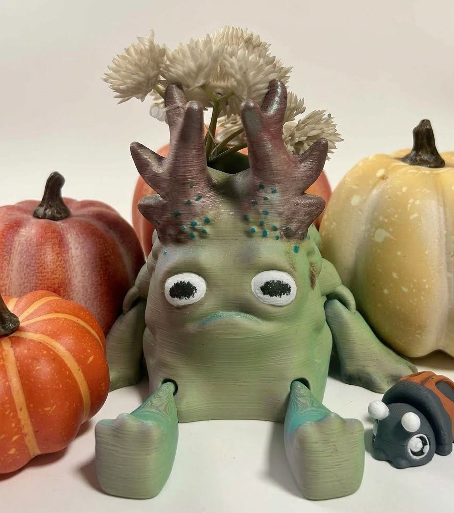 artisan-painted-moss-golem-planter, unique, cottagecore, collectables, Autumn Moss Golem, Articulated Golem planter, Layers in Green, Woodland guardian desk toy, Articulated forest monster, 3D printed desk companion, Moss monster pen holder, Cottagecore room decor, Dark academia desk accessories, Goblincore aesthetic decor, Mystical forest sculpture, Whimsical woodland gifts, Cozy cabin shelf styling, Fall harvest tabletop display, Grumpy pumpkin patch companion, Cute Halloween monster decor, Autumn
